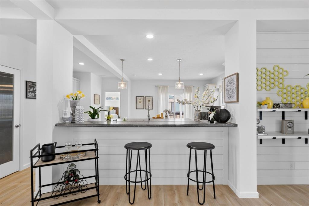 204 Doss Lane Moody, TX 76557 - Photo 8 of 19 a kitchen with stools a sink and cabinets
