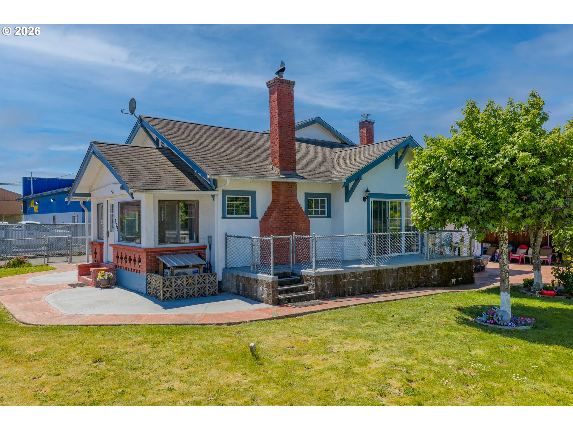 208 7th Street Myrtle Point, OR 97458 - Photo 2 of 48 a front view of a house with a yard table and chairs