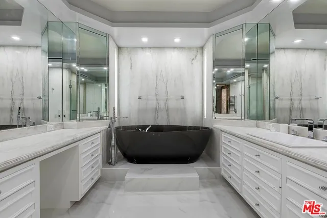 a bathroom with a sink a vanity and a mirror