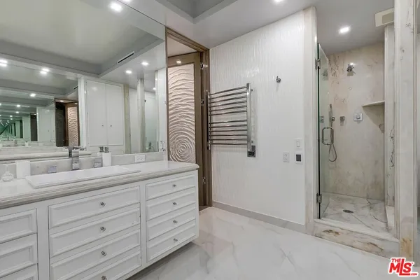 a bathroom with a granite countertop sink mirror and shower