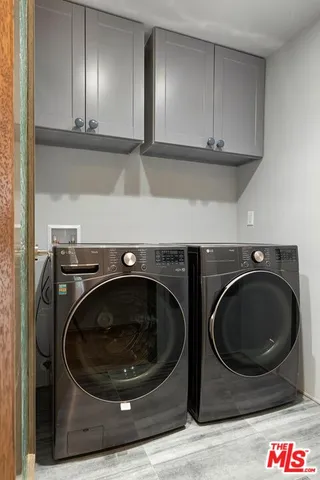 a utility room with sink dryer and washer