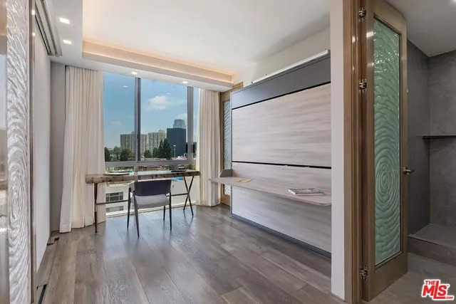 a view of a room with a furniture and floor to ceiling window