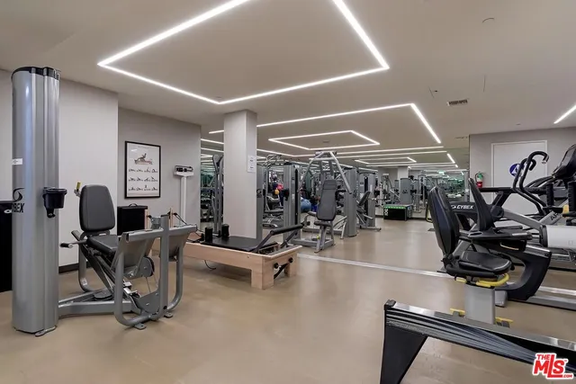 a view of building with swimming pool and chairs