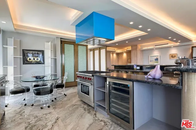 a kitchen with stainless steel appliances kitchen island granite countertop a sink and cabinets