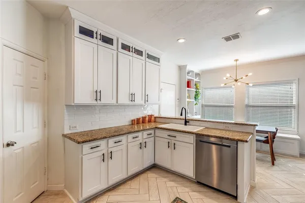 a kitchen with a sink window and cabinets