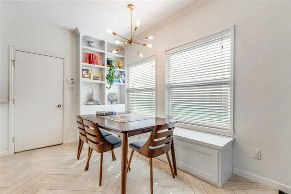 a view of a dining room with furniture and chandelier