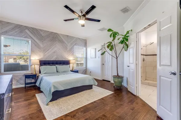 a bedroom with a bed chandelier and a window