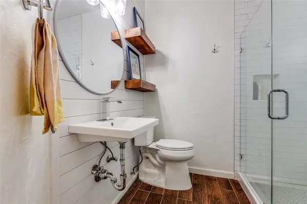 a bathroom with a sink toilet and a mirror