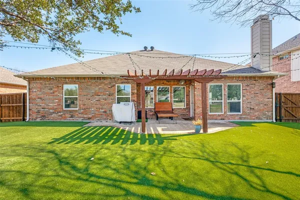 a view of a house with a yard patio and fire pit