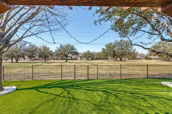 a view of outdoor space with iron fence