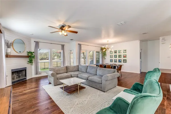 a living room with furniture fireplace and a large window