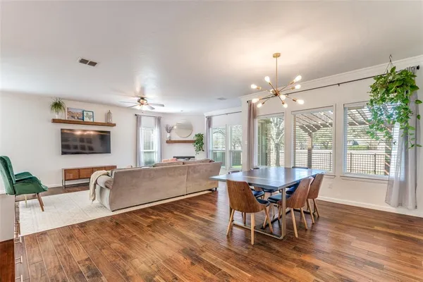 a view of a dining room with furniture window and wooden floor