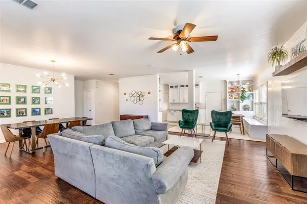 a living room with furniture and wooden floor