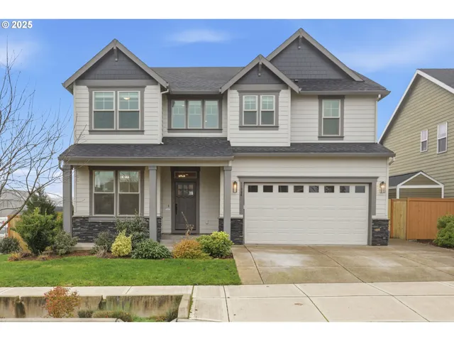 a front view of a house with a yard and garage