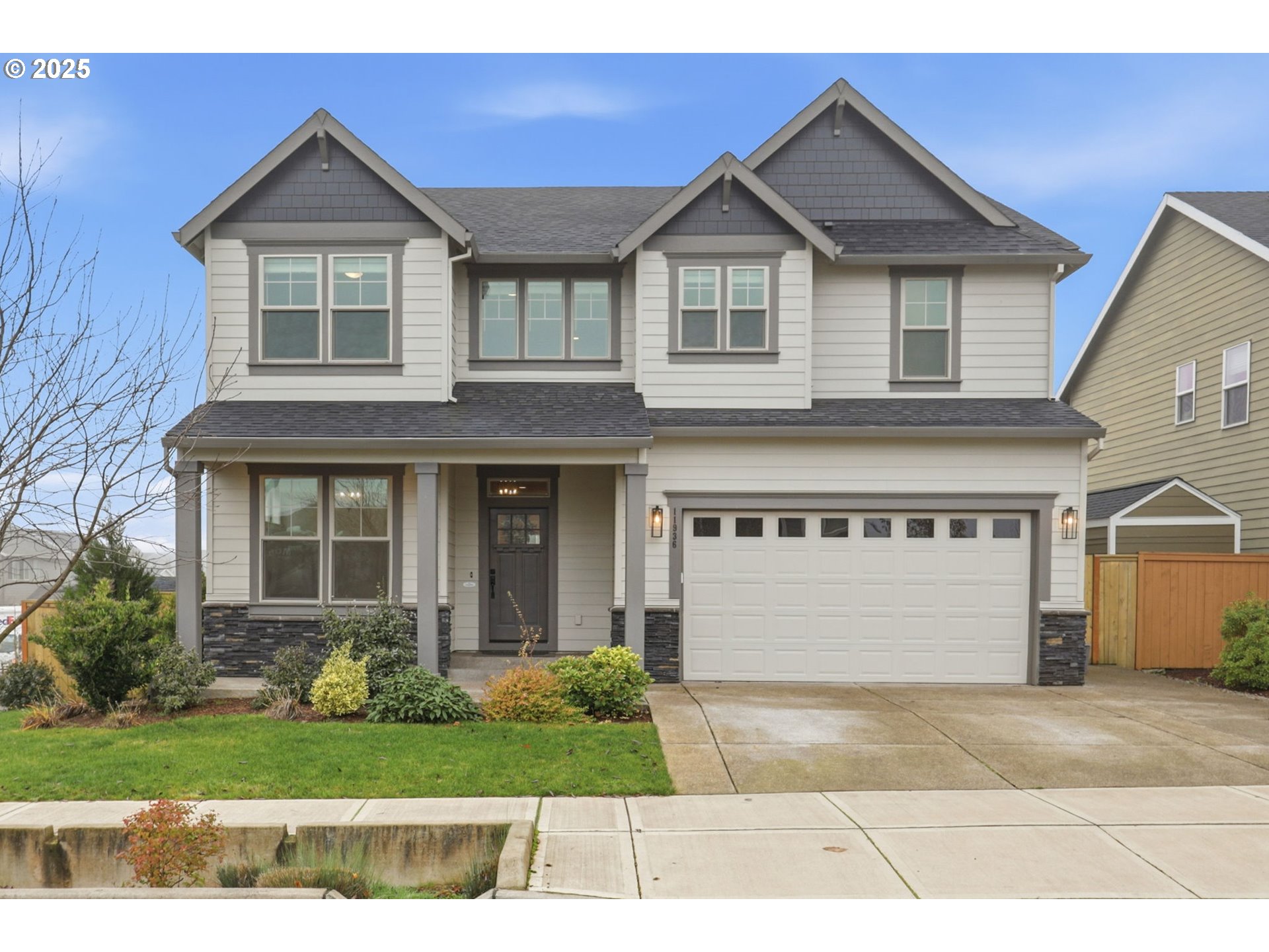 a front view of a house with a yard and garage