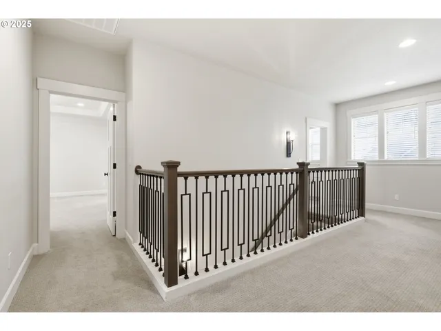 a view of a hallway to a livingroom with stair