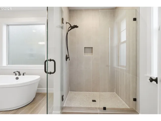 a bathroom with a bathtub and shower