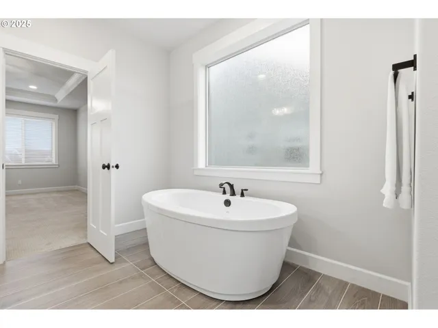 a white bath tub sitting next to a white sink