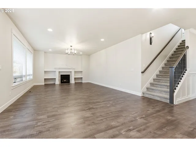 a view of kitchen and hall with wooden floor