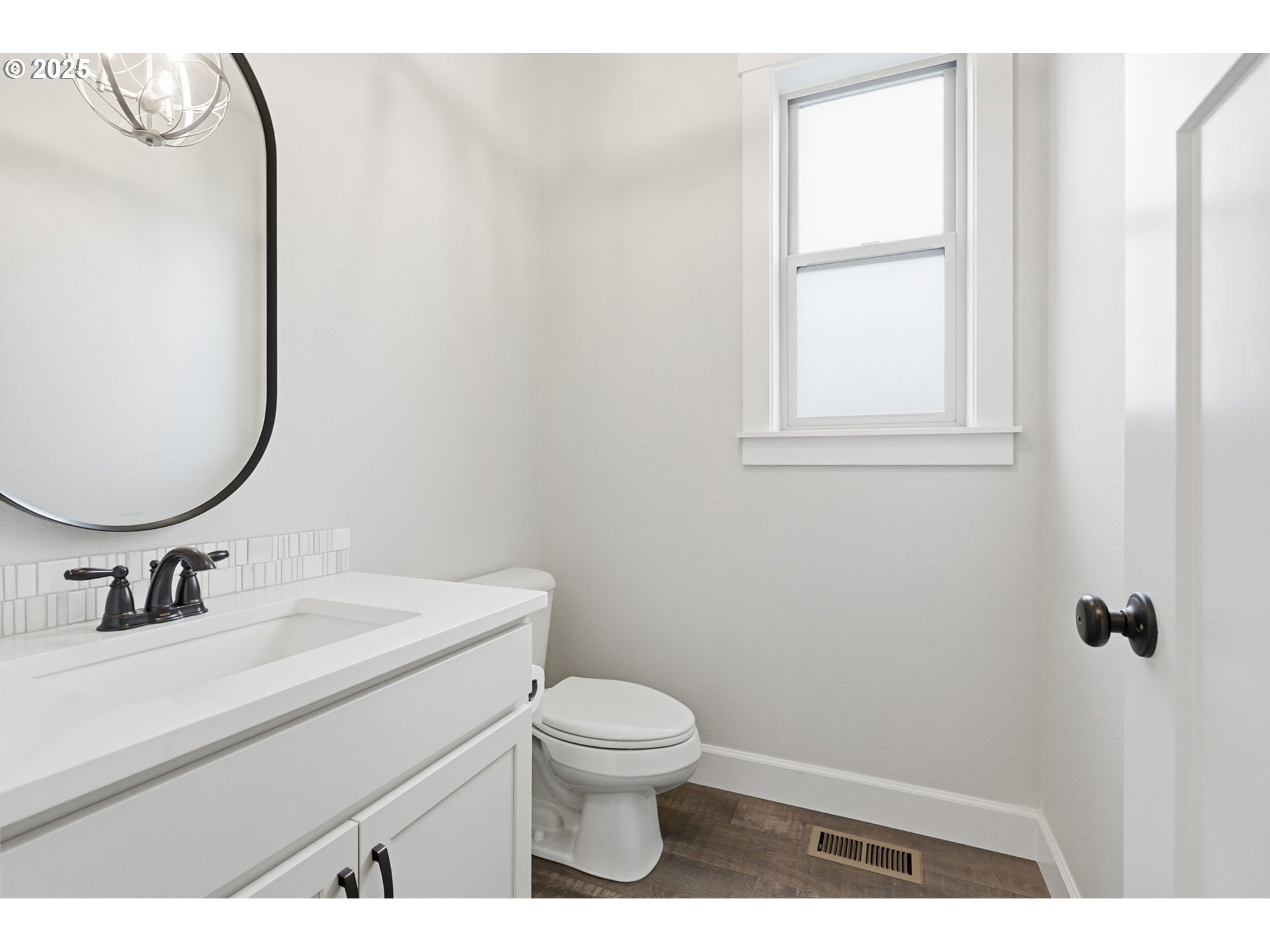11936 Skellenger Way Oregon City, OR 97045 - Photo 9 of 32 a bathroom with a toilet sink vanity and mirror