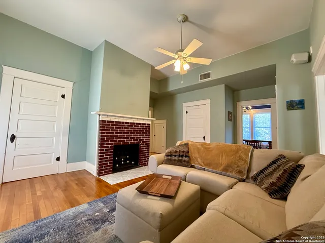 a living room with furniture and a fireplace
