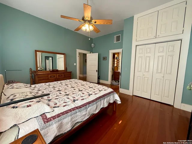 a bedroom with a bed and a dresser in it