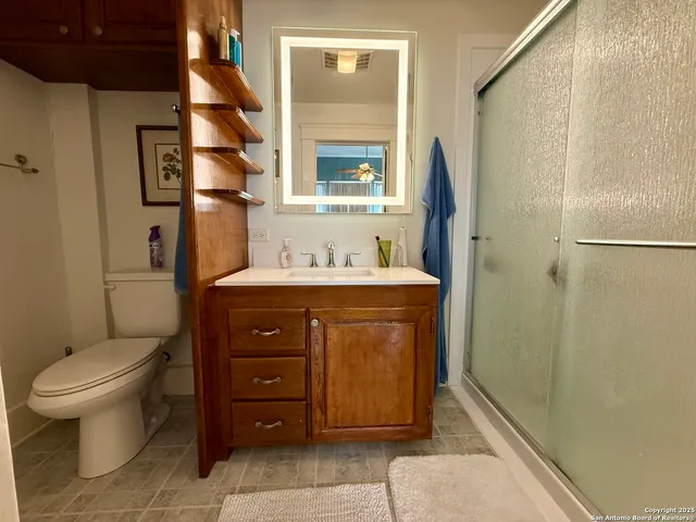 a bathroom with a sink toilet and shower