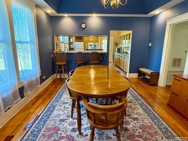 a dining room with furniture lamps and wooden floor
