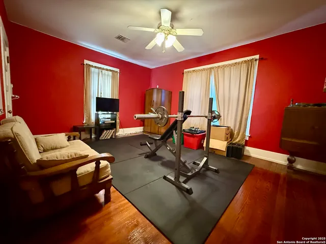 a living room with furniture gym equipment and a flat screen tv