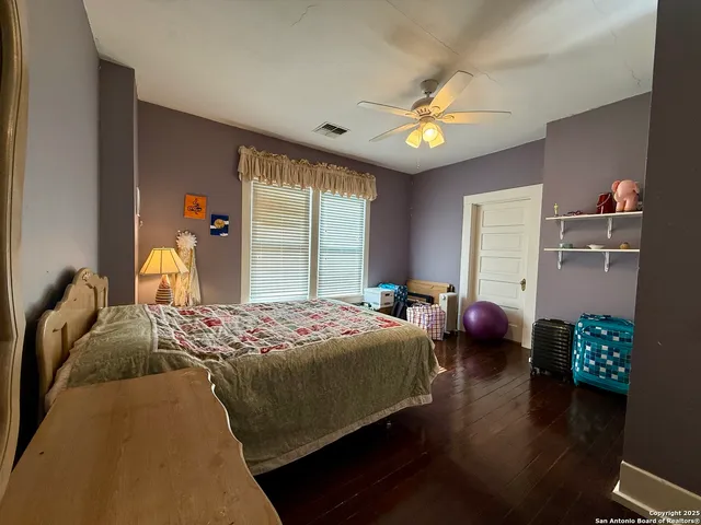 a bedroom with bed and a chandelier
