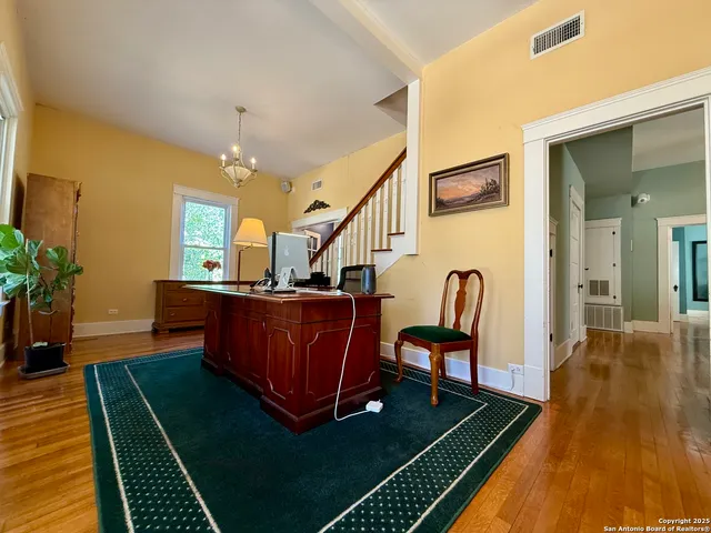 a living room with furniture rug and wooden floor