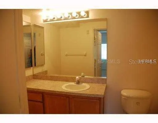 a bathroom with a sink a mirror and a shower