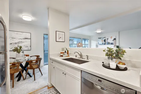 a kitchen with stainless steel appliances a stove microwave and sink
