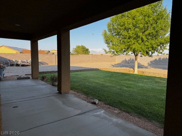 3744 River Heights Lane Logandale, NV 89021 - Photo 13 of 17 A spacious covered patio opens to a vibrant green lawn and a fully fenced yard, perfect for outdoor living.