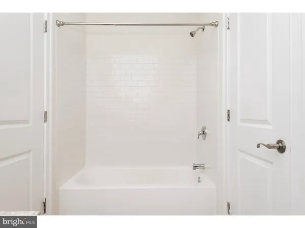 a bathroom with a shower and a bath tub