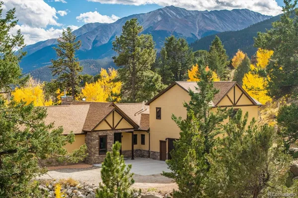 a view of a house with a yard and garden