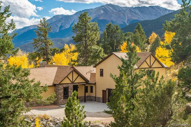 a view of a house with a yard and garden