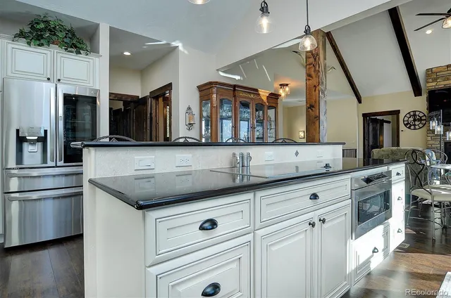 a kitchen with stainless steel appliances granite countertop a sink and a stove