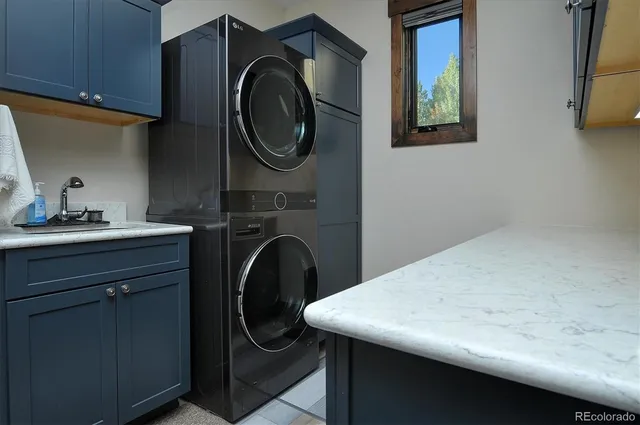 a utility room with a sink washer and dryer