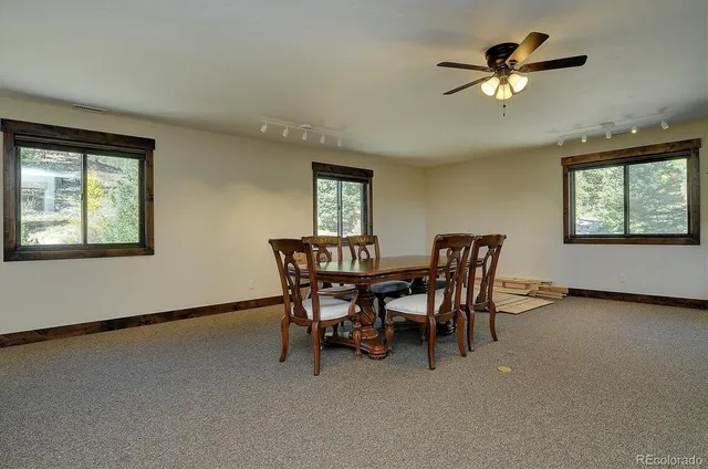 a view of a dining room with furniture and chandelier