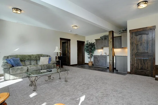 a living room with furniture and a lamp