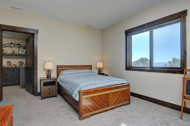 a bedroom with a bed and window