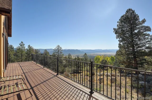 a view of a balcony with wooden floor and city view