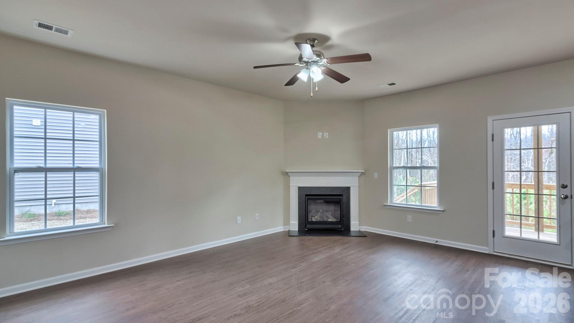 109 Piney Wds Road Fletcher, NC 28732 - Photo 12 of 28 a view of an empty room with a window and fireplace