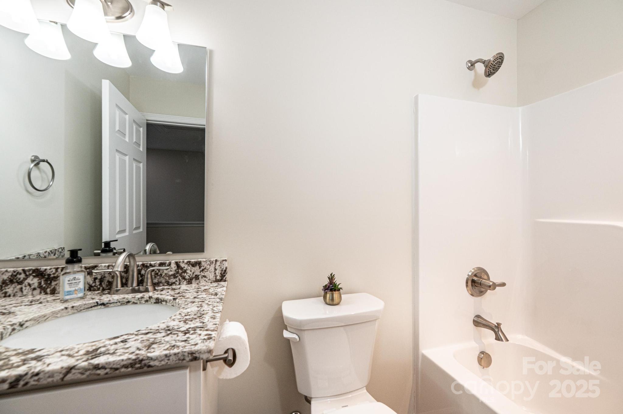 1214 Winter Place Lenoir, NC 28645 - Photo 13 of 19 a bathroom with a granite countertop sink and a mirror