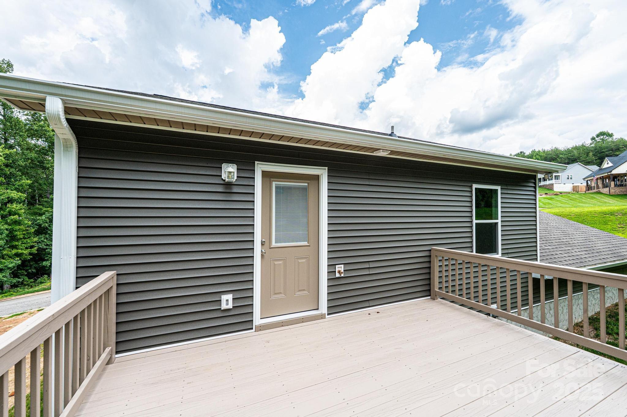 1214 Winter Place Lenoir, NC 28645 - Photo 17 of 19 a side view of a house with wooden fence
