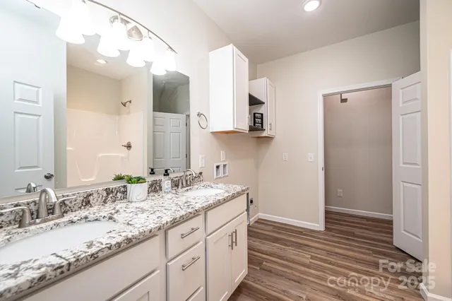 a bathroom with a granite countertop sink mirror and double