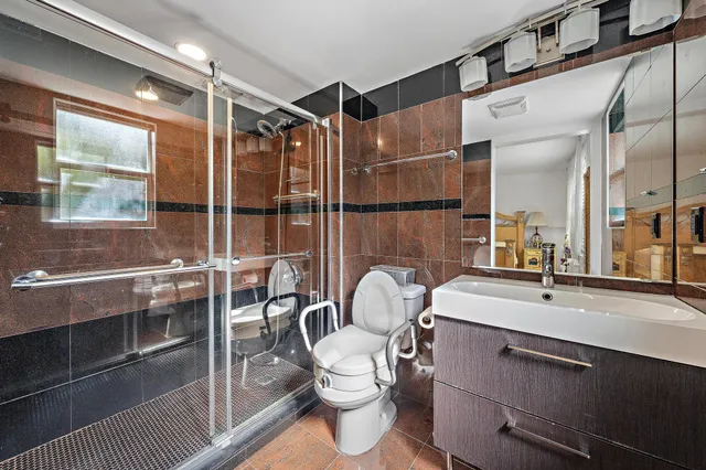 a bathroom with a sink mirror vanity and toilet