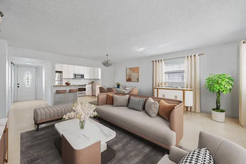 a living room with furniture and a potted plant