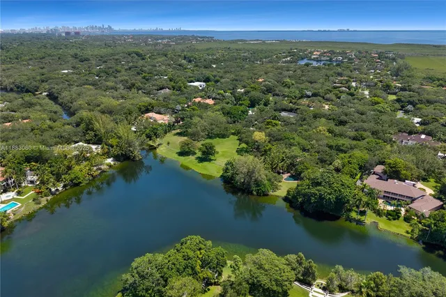 an aerial view of a houses with a lake view